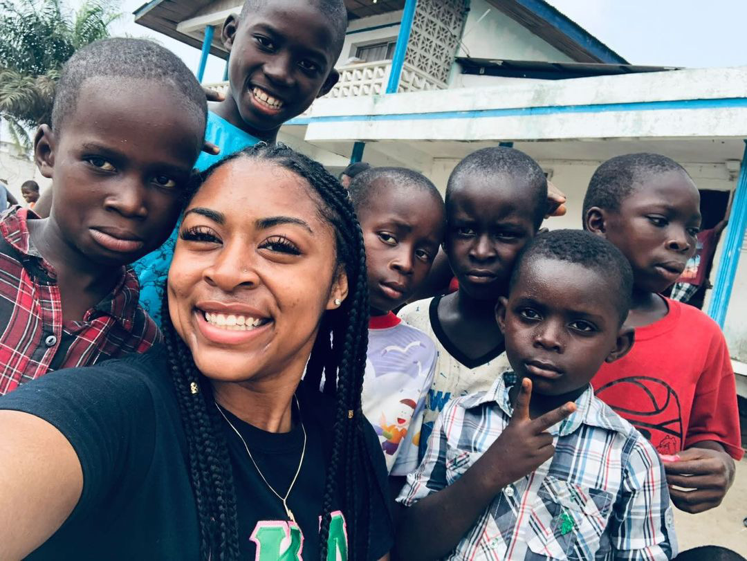PASI participant connecting with children during a community visit